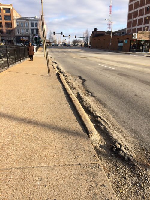 This curb on 14th Street has been decaying for years, getting worse each winter.